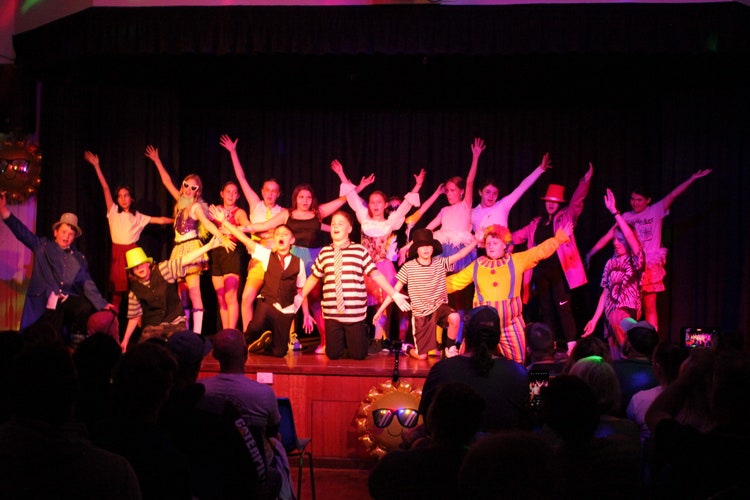 Students performing on stage in school hall
